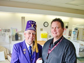 Ken Neumann (left), of the Pincher Creek Elks, and Jordan Koch (right), manager of the Pincher Creek Health Centre, hold the hospital’s new portable obstetrics ultrasound. John Stoesser photo/Pincher Creek Echo.