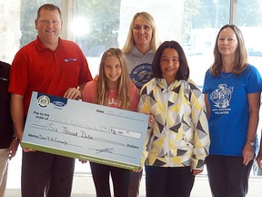 Progressive Ford's Terri Lynn Bechard, left, and Jered Sweet, present $6,000 to Christ the King's Olivia Alexander, Beth Fischer and Leanne Burgess, as well as Mitchell Bay Area Association's Carol Ann Belanger and Karen Miles for their participation in the Drive 4UR Community event held in July in Mitchell's Bay. The program is hosted by local Ford dealerships and benefits local organizations. Ford of Canada and local Ford Dealers partner up to host a charity test drive. Each household can count for one test drive and earn $20 towards the community organization.