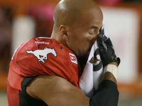 Stamps RB Jon Cornish wipes his face as he rides the bike during the final minute of play in CFL action in Calgary, Alta. between the Edmonton Eskimos and the Calgary Stampeders at McMahon Stadium on Saturday October 10, 2015. Jim Wells/Calgary Sun/Postmedia Network