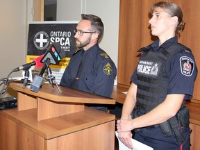 Ontario SPCA Insp. Brad Dewar, left, and Const. Renee Cowell, Chatham-Kent Police Service, field questions during a media conference to provide more details of a dog-fighting investigation on Wednesday. The joint forces operation led to the arrest of three people, each facing 96 charges, with 32 pit-bull type dogs seized, along with training devices and illegal drugs. PHOTO TAKEN on Wednesday October 14, 2015 in Chatham, Ont. (Vicki Gough/Chatham Daily News/Postmedia Network)