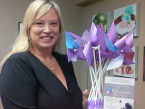 Commemorative event coordinator Katie Dean shows some of the pinwheels available for purchase for an inaugural Pregnancy and Infant Loss (PAIL) Network event in Sarnia this Saturday. Families, who have lost babies during pregnancy or infancy, will plant pinwheels in honour of them at Germain Park. (Handout/Sarnia Observer/Postmedia Network)