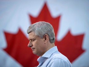 Conservative leader Stephen Harper pauses for a moment as he attends a campaign event at the J.P. Bowman tool and die company  in Brantford, Ont., Wednesday, Oct. 14, 2015.  THE CANADIAN PRESS/Jonathan Hayward