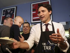 Liberal leader Justin Trudeau serves a piece of pie during a campaign stop at restaurant in Welland, Ontario October 14, 2015. (REUTERS/Chris Wattie)