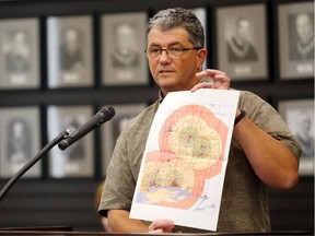 Hastings County GIS co-ordinator Nick January holds a map during a committee meeting in Belleville, Ont. Thursday, Oct. 11, 2014. He said a new map showing ambulance response times is more accurate than the more general version in his hands. 
Luke Hendry/Belleville Intelligencer/Postmedia Network