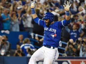 Toronto Blue Jays right fielder Jose Bautista (19) reacts after hitting a three-run home run against the Texas Rangers in the 7th inning in game five of the ALDS at Rogers Centre. Mandatory Credit: Peter Llewellyn-USA TODAY Sports