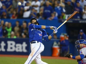 Jose Bautista of the Toronto Blue Jays hits a three-run home run in the 7th inning giving the Jays a 6-3 win against the Texas Rangers in game five of the American League Division Series in Toronto Wednesday October 14, 2015. (DAVE Abel/Toronto Sun)