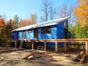 Cottage reno in progress: Cape Cod siding in black is to be laid over a blue skin breathable air barrier