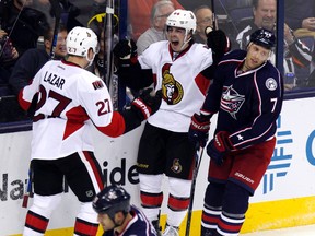 Ottawa Senators' Jean-Gabriel Pageau (44) celebrates with teammate Curtis Lazar (27) in front of Columbus Blue Jackets' Jack Johnson (7) after Pageau scored a goal during the third period of an NHL hockey game in Columbus, Ohio, Wednesday, Oct. 14, 2015. Ottawa won 7-3. (AP Photo/Paul Vernon)
