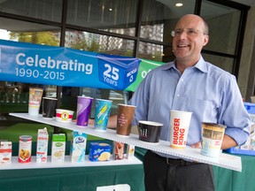 Mayor Matt Brown holds a collection of cups, items often mistaken as garbage that actually belong in the blue box, as he helps kick off Waste Reduction Week, taking place October 19 to 25, in London, Ont. on Wednesday October 14, 2015. Since it's inception in 1990, Londoners have saved approximately 4 million trees through the recycling program to date, with 45 percent of city waste being diverted from landfills.  To celebrate 25 years of recycling in London, residents can send in a photo of themselves with their original 1990 blue box, along with a paragraph on why they recycle, to be entered into a contest. (Craig Glover/The London Free Press/Postmedia Network)