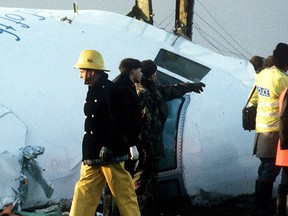 A Dec. 23, 1988 file photo shows Scottish rescue workers and crash investigators search the area around the cockpit of Pan Am flight 103 in a farmer's field east of Lockerbie, Scotland. REUTERS/Greg Bos