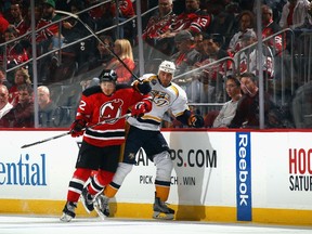 Jordin Tootoo of the New Jersey Devils and Eric Nystrom of the Nashville Predators battle along the boards during the first period at Prudential Center on October 13, 2015 in Newark, New Jersey. (Bruce Bennett/AFP)