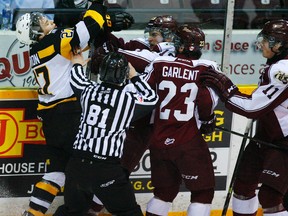 Kingston Frontenacs forward Cody Caron defends himself against Petes Josh Maguire and Hunter Garlent during OHL action in Peterborough last season. (Postmedia Network file photo)