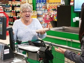 A Food Basics shopper in Sarnia reacts after learning Shell is paying for and bagging her groceries. The gesture was part of Shell's Fuelling Kindness event, a two-day blitz where unsuspecting residents were treated to random acts of kindness. Handout/Sarnia Observer/Postmedia Network