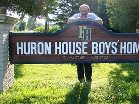 Huron House Boys' Home executive director Don Adam stands at the sign for the Bright's Grove refuge for wayward boys. The mental health facility was holding an open house in honour of its 45th anniversary Thursday. Handout/Sarnia Observer/Postmedia Network