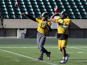Mike Reilly, left, and James Franklin toss the ball during Eskimos practice on Tuesday at Commonwealth Stadium. (Perry Mah, Edmonton Sun)