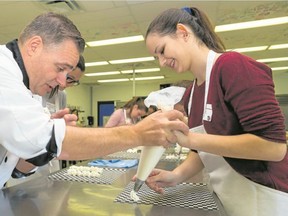 Tim Miller/The Intelligencer
Chef John Schneeberger helps St. Mary's Secondary School student Maiah Capel prepare icing for an eclair during some hands-on learning as part of Loyalist College's School College Work Initiative (SCWI) Taste of College on Thursday in Belleville.