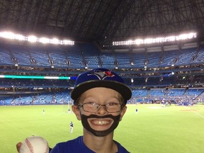 Nine-year-old Oscar Wood aka Mini Bautista at the Rangers-Blue Jays game in Toronto on Wednesday, Oct. 14, 2015. (THE CANADIAN PRESS/ho-Benn Wood)