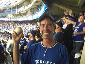 Scott Bell leaped from his seat in the Rogers Centre on Wednesday night and--armed with his baseball mitt from Forester Falls, Ont.--managed to catch Blue Jays' slugger Edwin Encarnacion's home run ball. He held it on the train on his way home to the Ottawa Valley on Thursday.PHOTO COURTESY OF SCOTT BELL