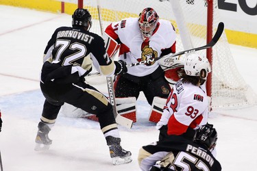 Pittsburgh Penguins' Patric Hornqvist (72) looks for a rebound off Ottawa Senators goalie Craig Anderson (41) on a shot by David Perron (57) during the first period of an NHL hockey game in Pittsburgh Thursday, Oct. 15, 2015.(AP Photo/Gene J. Puskar)