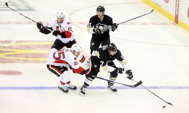 Oct 15, 2015; Pittsburgh, PA, USA; Pittsburgh Penguins center Matt Cullen (7) chases the puck as Ottawa Senators right wing Chris Neil (25) pressures during the second period at the CONSOL Energy Center. Mandatory Credit: Charles LeClaire-USA TODAY Sports