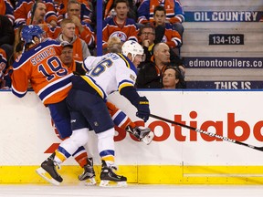 Blues centre Paul Stastny checks Oilers defenceman Ryan Schultz against the boards during Thursday's game at Rexall Place. (Ian Kucerak, Edmonton Sun)