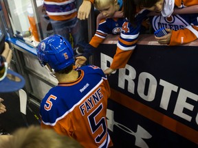 Oilers fans greet the team, including defenceman Mark Fayne (5), as they head to the ice for warmup before a NHL game between the Edmonton Oilers and the St. Louis Blues at Rexall Place in Edmonton, Alta. on Thursday October 15, 2015. Ian Kucerak/Edmonton Sun/Postmedia Network