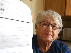 Jean Wright shows off a invoice of more than $6,000 for an Alberta air ambulance flight on Thursday. Wright required medical care involving an air ambulance while on vacation in Alberta. Gino Donato/Sudbury Star/Postmedia Network