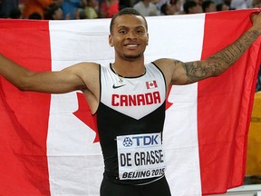 Andre De Grasse celebrates after winning the bronze medal in the men's 100m at the World Athletics Championships at the Bird's Nest stadium in Beijing, Sunday, Aug. 23, 2015. THE CANADIAN PRESS/AP/Lee Jin-man