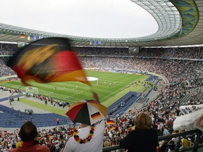 A Germany supporter waves a flag as the teams warm up before the start of the quarter-final World Cup football match between Germany and Argentina at Berlin's Olympic Stadium, 30 June 2006. The German Football Federation insisted on October 16, 2015 that a 6,7 million euro ($7,6 million) payment made by the 2006 World Cup organisers to FIFA had nothing to do with the awarding of the event to Germany. (AFP/ ROBERTO SCHMIDT)