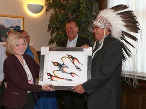 Grand Chief Charles Weaselhead and Alberta Premier Rachel Notley exchange gifts and handshakes in Calgary, Alta following the Alberta–Treaty 7 First Nations meeting on Friday October 16, 2015. Jim Wells/Calgary Sun/Postmedia Network