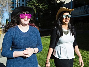 Sarah Von Gertzen, left, who suffers from social anxiety, and Dr. Joti Brar-Josan, a registered provisional psychologist, walk along 118 Street near 100 Avenue in silly eyewear in Edmonton, Alta., on Friday, Oct. 16, 2015. The eyewear is part of Fright Night, which is an exposure-based cognitive behavioural therapy program that challenges patients with anxiety and phobia to face their fears head on. Codie McLachlan/Edmonton Sun