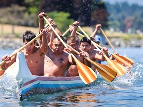 First Nations competitors from Rainbow Canoe Club in Kulleet Bay race to the line in the first aboriginal war canoe race in over 100 years in the Inner Harbour of Victoria June 27, 2015. (REUTERS/Kevin Light)