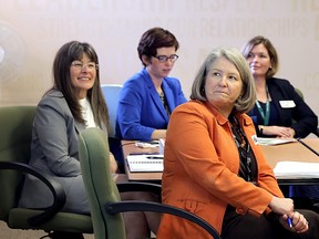 Kingston and the Islands MPP Sophie Kiwala, left, Karin Carmichael, right, and Jenn Goodwin, both of Providence Care during an advisory committee meeting on mental health issues at Providence Care Mental Health services site in Kingston on Friday. (Ian MacAlpine/The Whig-Standard)