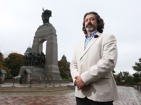 Martin Magnan stands in front of the National War Memorial in Ottawa Ontario Friday Oct 9, 2015. Martin was one of the bystanders who tried to help Nathan Cirillo after he was shot Oct 22 of last year on the War Memorial. Tony Caldwell/Ottawa Sun/Postmedia Network