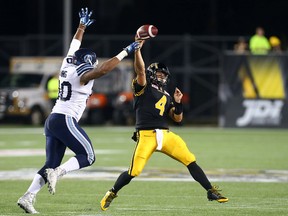Argos' Cleyon Laing tries to intercept a pass from Tiger-Cats quarterback Zach Collaros during CFL action in Hamilton, Ont., on Aug. 3, 2015. (Dave Abel/Toronto Sun)