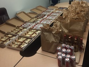 Various types of alcoholic beverages are shown from a seizure at a pizza shop in Edmonton in this police handout photo. Edmonton Police obtained a search warrant and seized a total of 240 cans of beer, and 100 bottles of various spirits at the establishment inside pizza boxes, in pre-packaged brown paper bags and inside delivery vehicles. THE CANADIAN PRESS/HO-Edmonton Police Service