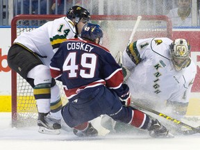 Saginaw Spirit forward Cole Coskey sends a cloud into London goalie Tyler Parsons as he attempts to score while under pressure from Knights defenceman Brandon Crawley at Budweiser Gardens on Friday night. (CRAIG GLOVER, The London Free Press)