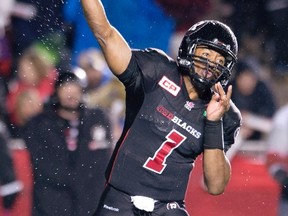 Water spins off the ball as Ottawa RedBlacks quarterback Henry Burris attempts a pass during first half CFL action in Ottawa, Friday, Oct. 16, 2015. THE CANADIAN PRESS/Adrian Wyld