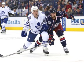 Maple Leafs forward Leo Komarov battles for the puck with Brandon Dubinsky of the Blue Jackets in the first period in Columbus on Oct. 16, 2015. Komarov had two late goals in the Leafs’ 6-3 win. (AARON DOSTER/USA Today Sports)