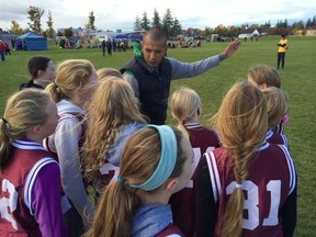 Running coach for St. James Catholic Elementary School,  Eddie Lopez, gives some tips before the race. (Contributed photo)
