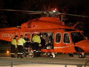 A civilian shooting victim is loaded into an air ambulance after a shooting in Brampton late Friday, Oct. 16, 2015. (JOHN HANLEY/Special to the Toronto Sun)