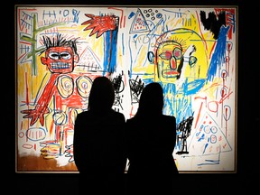 Christie's employees pose with Jean-Michel Basquiat's Untitled artwork at Christie's Auction House in London June 7, 2013.  The artwork forms part of an exhibition "Masterpieces at Christie's" which which commences the summer auction season. REUTERS/Luke MacGregor