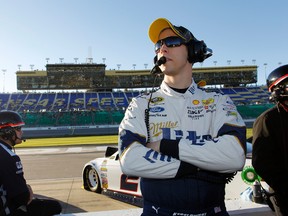 NASCAR driver Brad Keselowski watches Sprint Cup qualifying from pit road at Kansas Speedway in Kansas City, Kan. on Oct. 16, 2015. (AP Photo/Colin E. Braley)