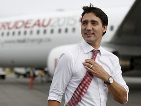 Liberal leader Justin Trudeau walks on the tarmac in front of his campaign plane after arriving in Saint John, New Brunswick, October 17, 2015. REUTERS/Chris Wattie