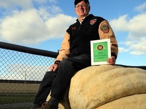 Todd Kline of Shawville, Que. sits atop his champion squash at Saturday's Prince Edward County Pumpkinfest. It weighed 1,533.5 lbs, making it the second-largest squash ever grown, the largest in the world this year, and a Canadian record.