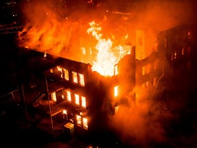 Flames rip through a century-old, heritage building, Leamington Mansions – which were originally built in 1914 and opened in 1918 – on Jasper Avenue and 114 Street in Edmonton, AB on Saturday, October 17, 2015. David Hernandez/Edmonton Sun Reader
