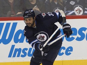 Dustin Byfuglien of the Winnipeg Jets breaks his stick as he attempts a shot on goal in third period action in an NHL game on Oct. 16, 2015 in Winnipeg. (Marianne Helm/Getty Images/AFP)