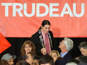 Winnipeg Centre candidate Robert-Falcon Ouellette greets Winnipeg South Centre candidate Jim Carr during a rally with Liberal leader Justin Trudeau at St. James Civic Centre in Winnipeg Oct. 17, 2015. (Kevin King/Winnipeg Sun/Postmedia Network)
