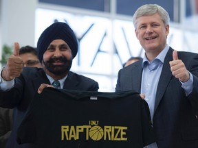 Conservative leader Stephen Harper poses with Nav Bhatia at the latter's Mississauga car dealership on Sunday. (THE CANADIAN PRESS)