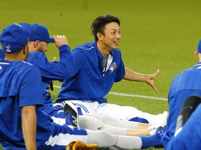 Munenori Kawasaki jokes with the team during stretching as the Toronto Blue Jays held an optional workout at the Rogers Centre in Toronto on Oct. 13, 2015. (Michael Peake/Toronto Sun/Postmedia Network)